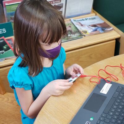 Child at Library playing with STEM Kit